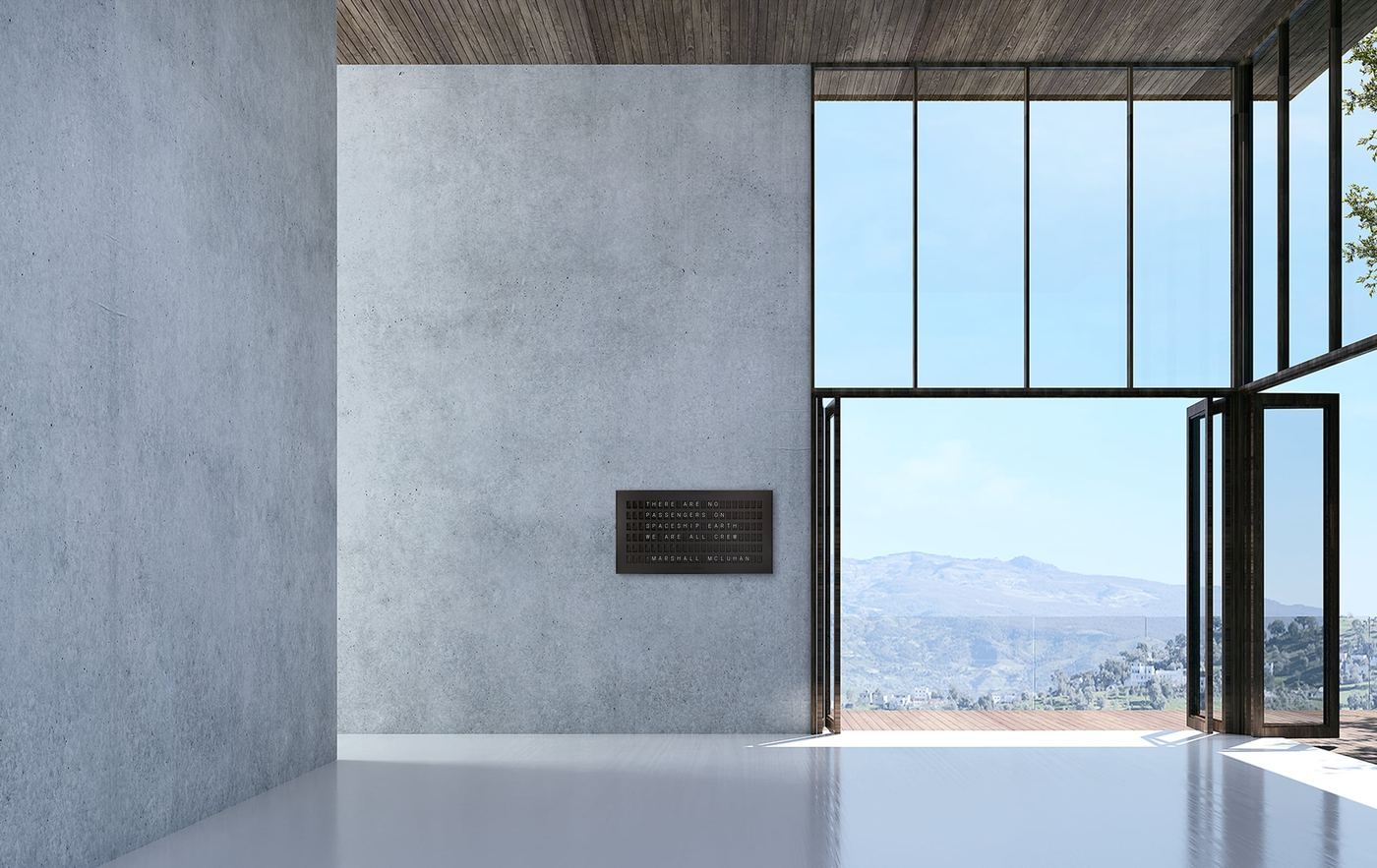 A Vestaboard split-flap display mounted on a concrete wall in a modern architectural space